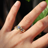 sapphire forget me not engagement ring with a leaf wedding band